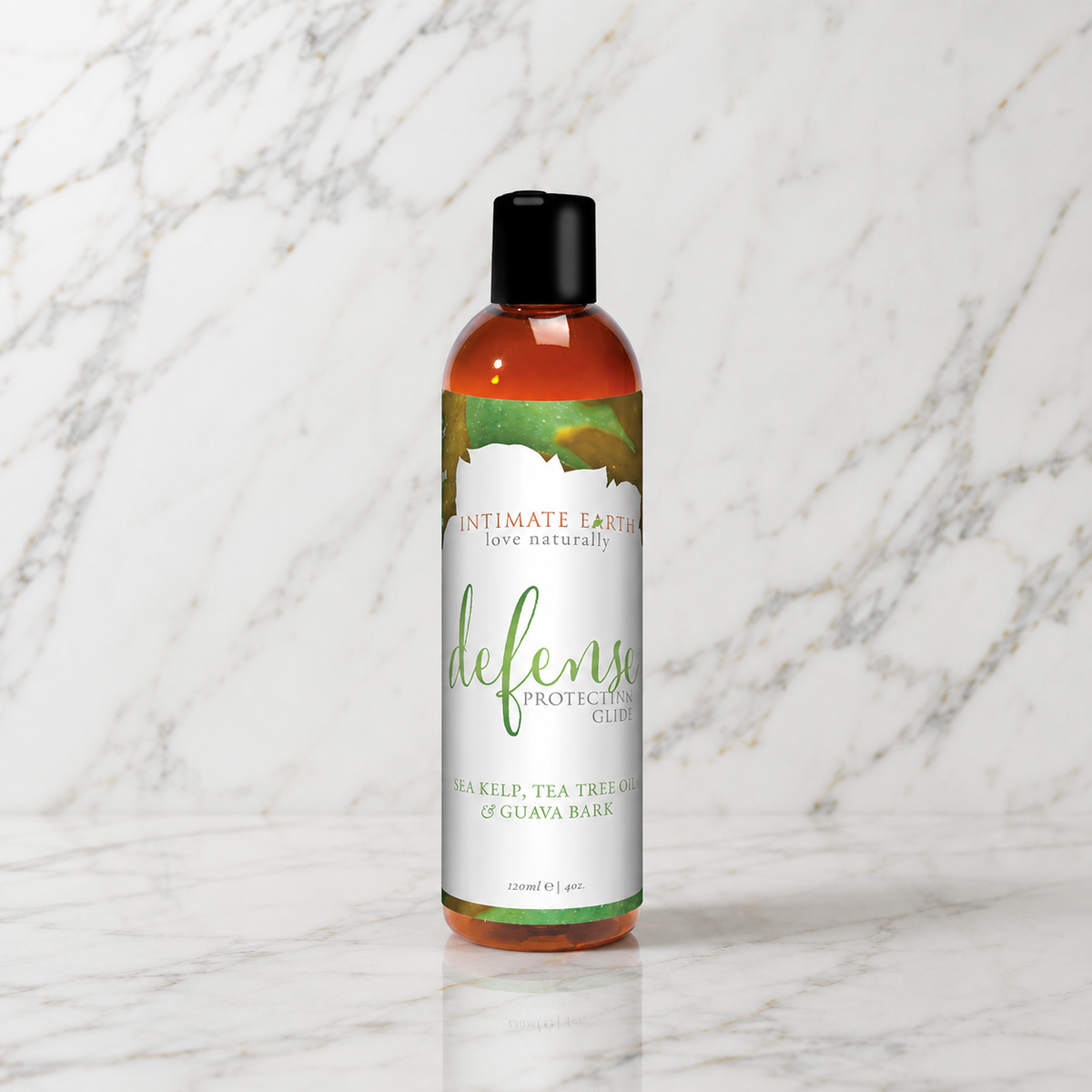 Fles Defense glijmiddel met groen-wit etiket op een marmeren plank, Intimate Earth