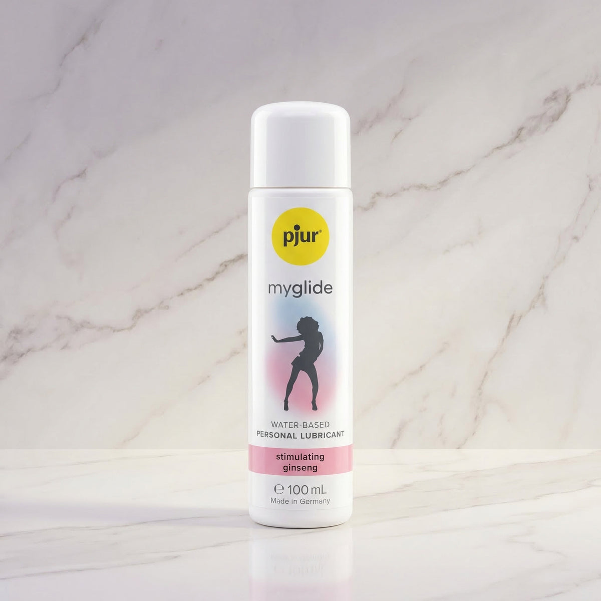 Witte fles pjur myglide 100 ml met silhouet van een dansende vrouw op een marmeren plank