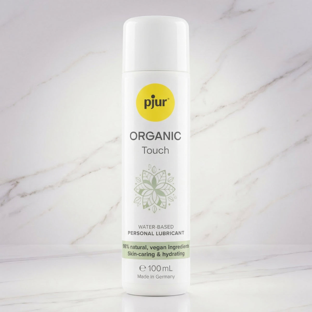 Witte fles pjur Organic Touch glijmiddel op een marmeren plank, 100 ml
