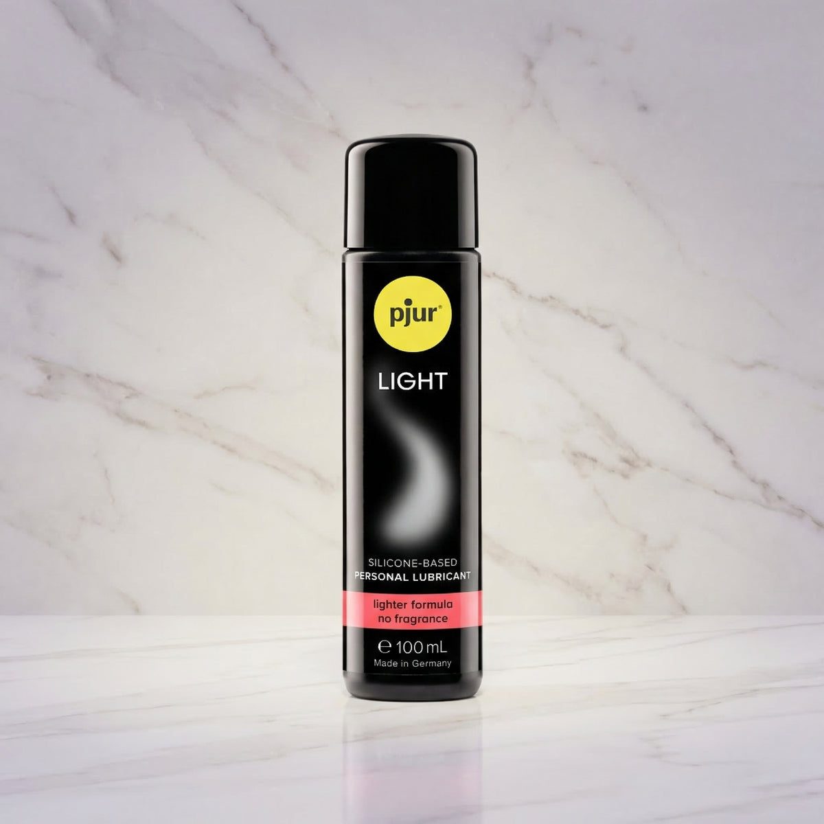 Zwarte fles pjur LIGHT 100 ml rechtop op een marmeren plank