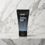 Zwart-grijze tube Delay Gel for men rechtop op een marmeren plank, coolMann