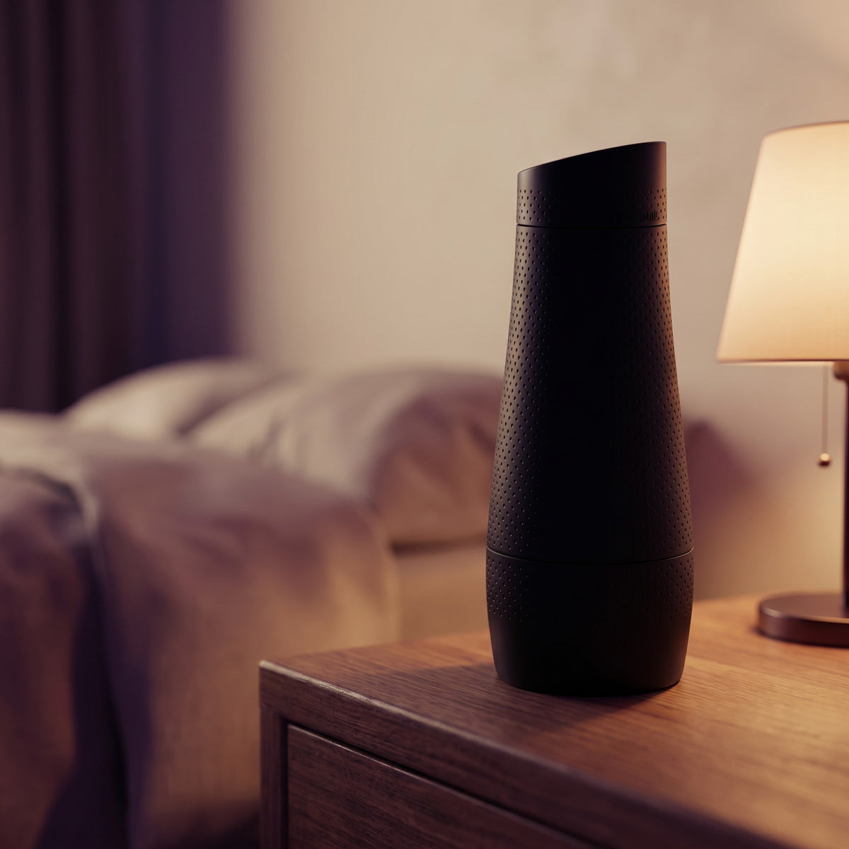Sfeerbeeld: zwarte Fleshlight Flight Pilot op een houten nachtkastje bij lamplicht
