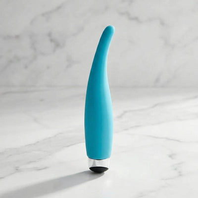Slanke turquoise vibrator met gebogen tip, staand op een marmeren ondergrond