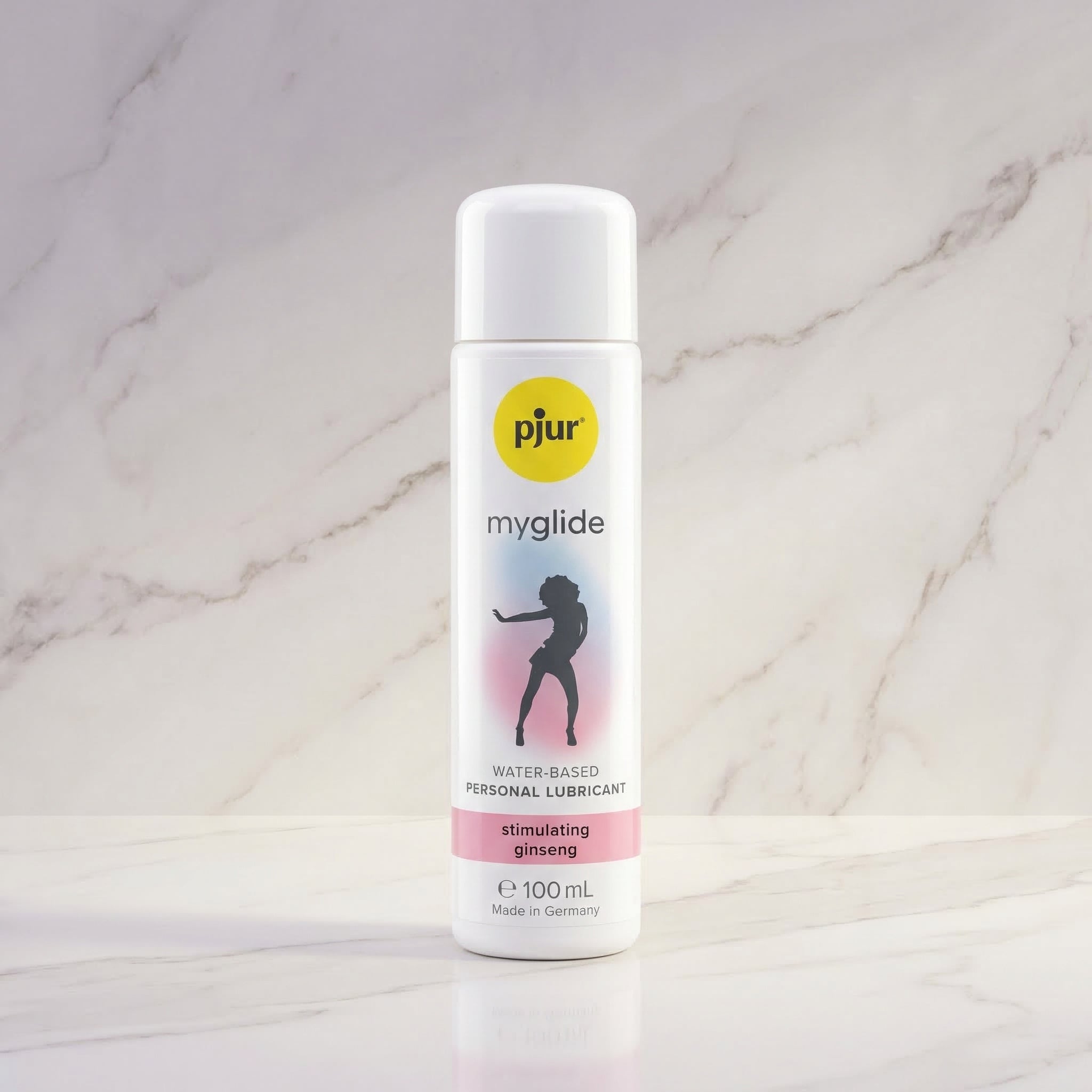 Witte fles pjur myglide 100 ml met silhouet van een dansende vrouw op een marmeren plank