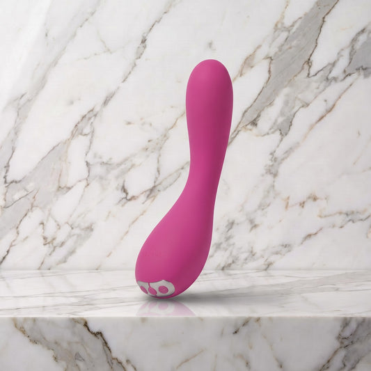 Roze gebogen vibrator rechtop op een marmeren plank, Je Joue Uma