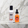 Flesje Divine Nectars en flesje Oil of Love Tropical Mango op een marmeren plank, Kama Sutra