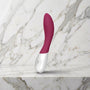 Lelo Mona Wave g-spot vibrator in deep rose op een marmeren plank