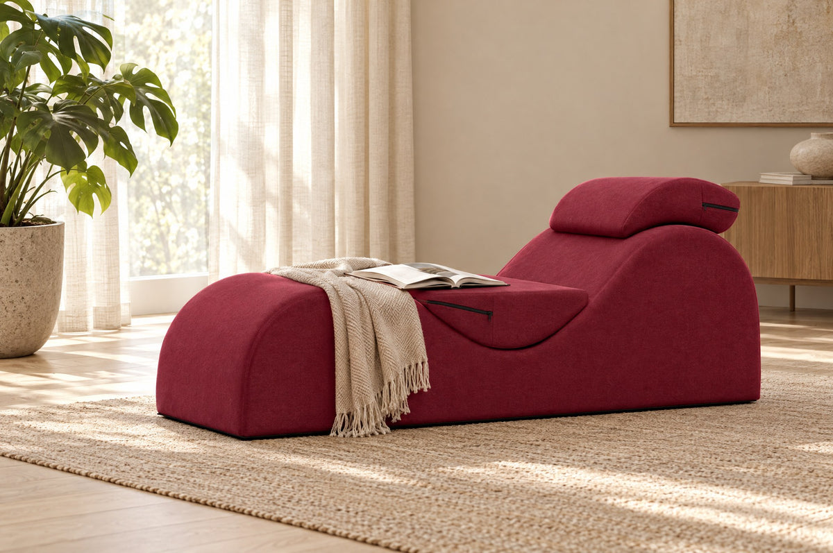 Rode Liberator Esse Lounger met een plaid en een open boek in een lichte woonkamer