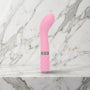 Lichtroze Sassy G-spot vibrator met brede kop op een marmeren plank