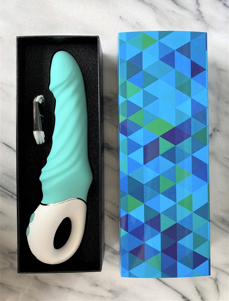 Sea Star in de open doos met USB-oplaadkabel, naast de blauwe geometrische buitenverpakking