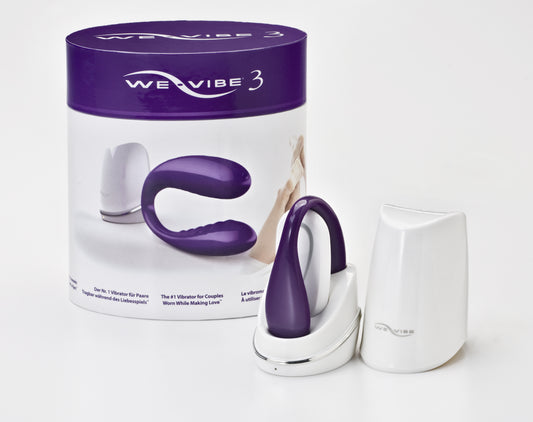We-Vibe 3 in paars-witte cilindrische verpakking met vibrator en accessoires
